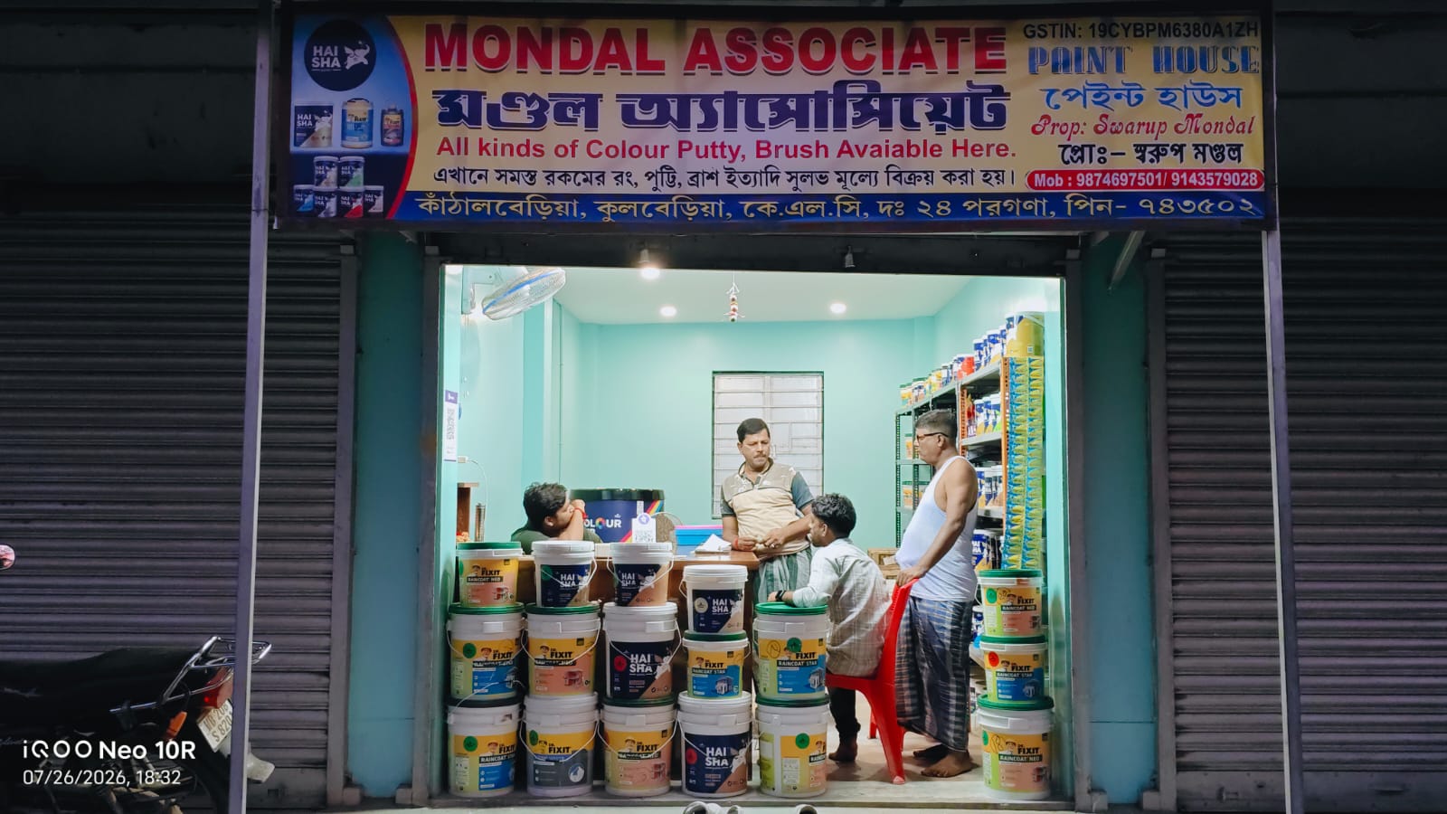Inside Mondal Associate Paint House with shelves of paint and waterproofing products